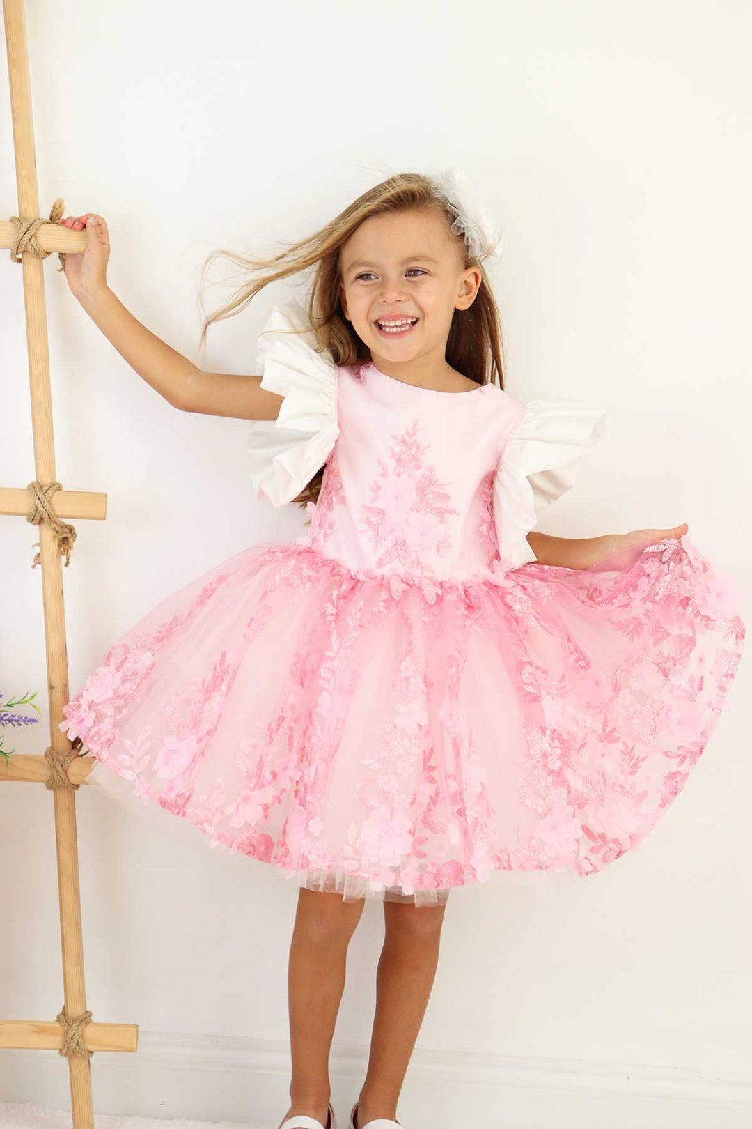 A pink birthday party dress. The dress has 3D floral design, puffy skirt, and balloon arm