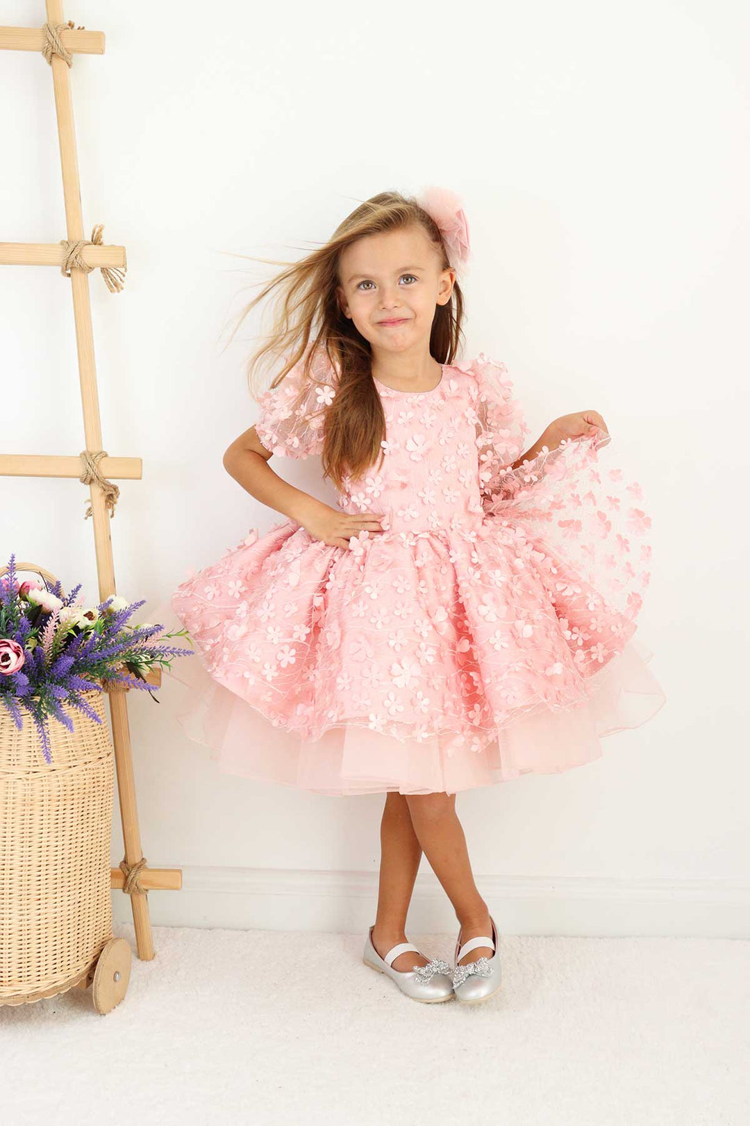 A pink floral dance dress that has 3D flowers, balloon arm and grainy tulle layers inside the skirt