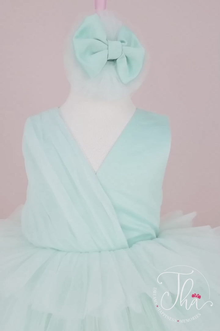 360° view of a tiffany sleeveless mint themed party dress that has knee length multi layered puffy skirt and V-neck