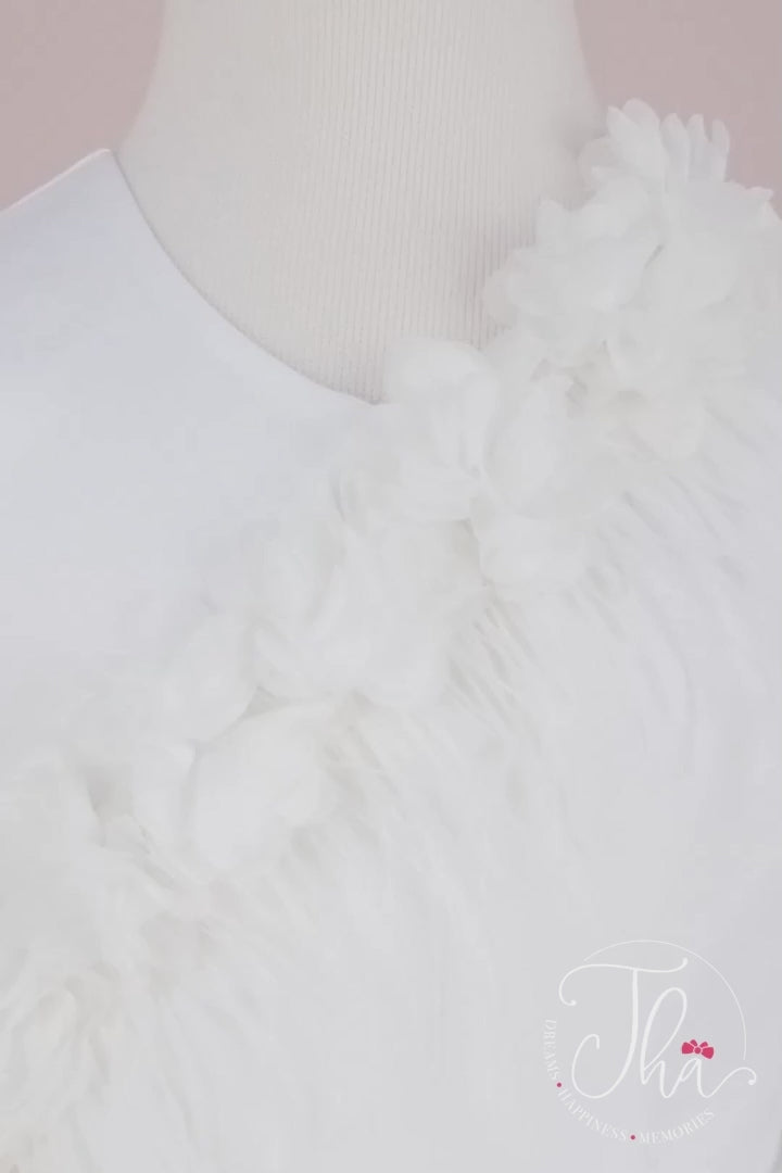360° view of a white sleeveless fairy dress that has 3D flowers, feathers, shirring detail, V design, bow, and knee length skirt