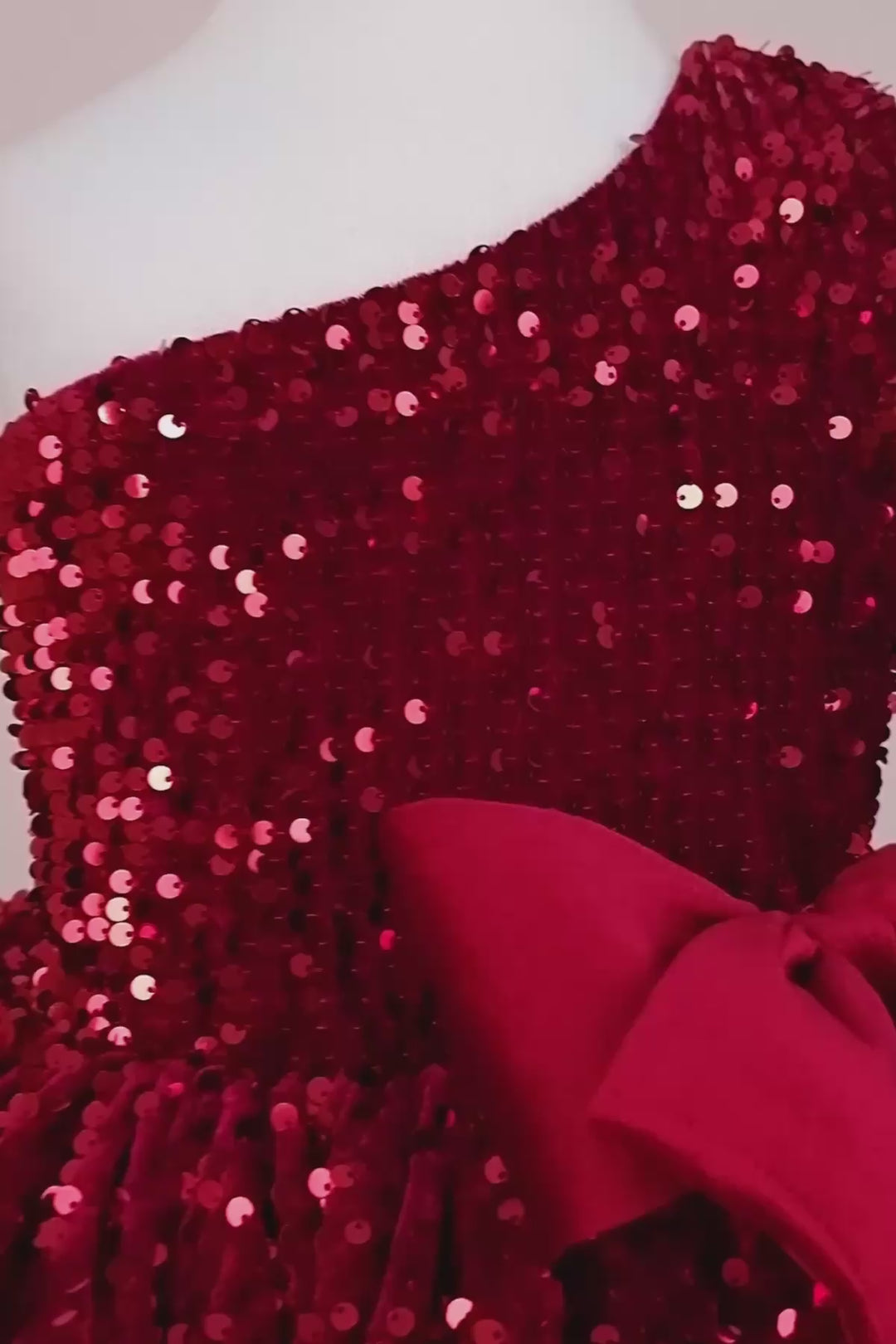 360° view of a red hologram sequin one shoulder open Christmas dress that has velvet ribbon and knee length skirt