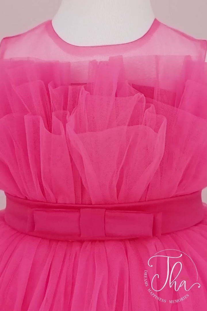 360° view of a fuchsia sleeveless tutu dress that has knee length fluffy multi layered skirt, belt, and fuchsia illusion collar