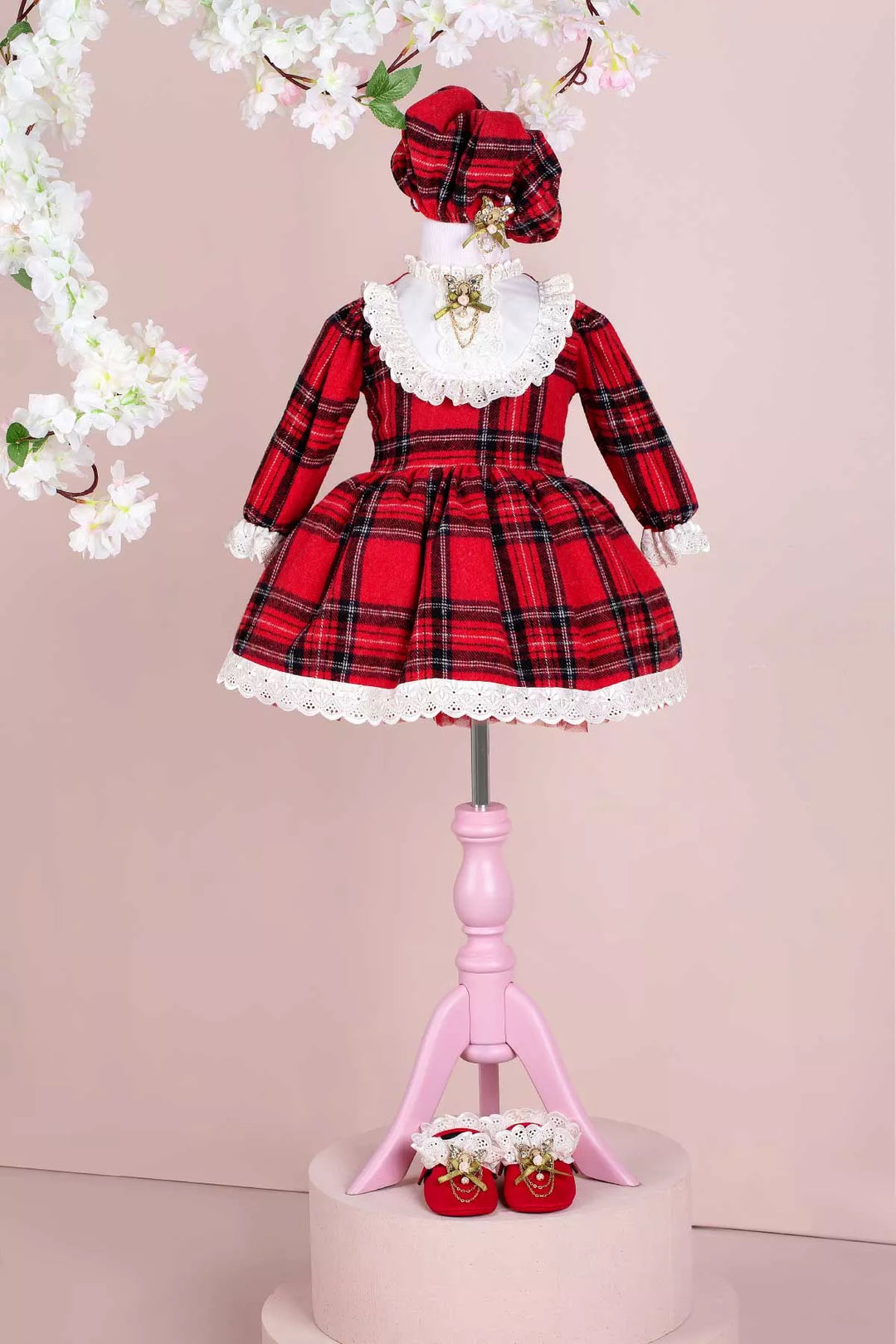 A red plaid print velvet Christmas dress set that has long sleeves, hat, brooch, and shoes