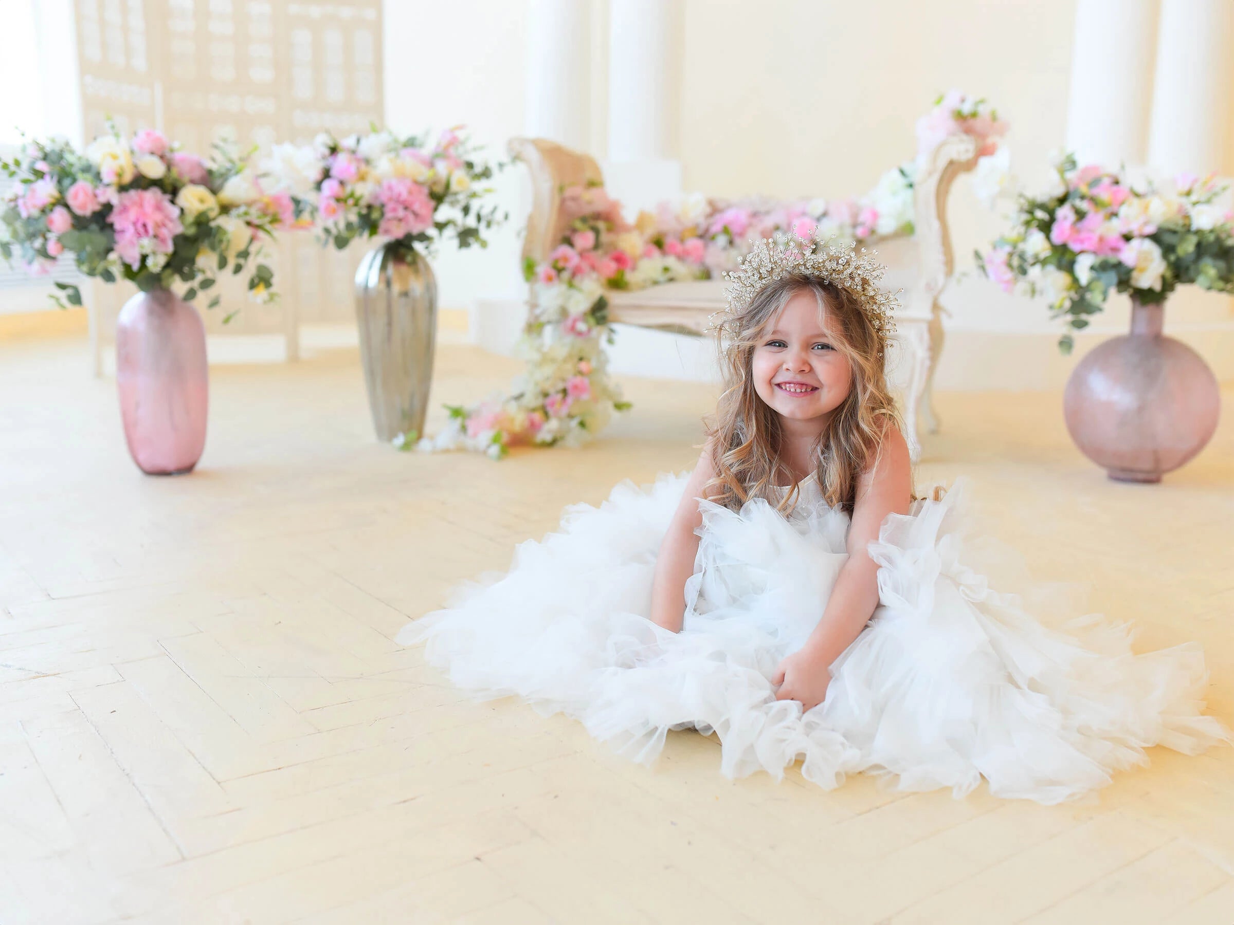 A girl wearing first birthday dress.