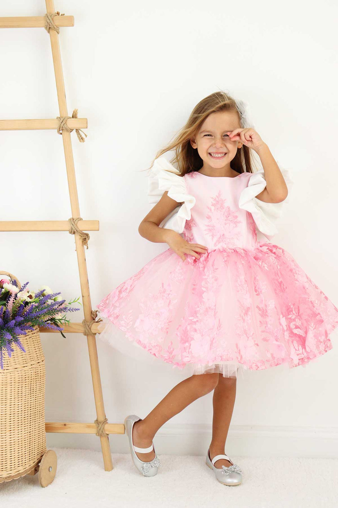 A pink birthday party dress. The dress has 3D floral design, puffy skirt, and balloon arm