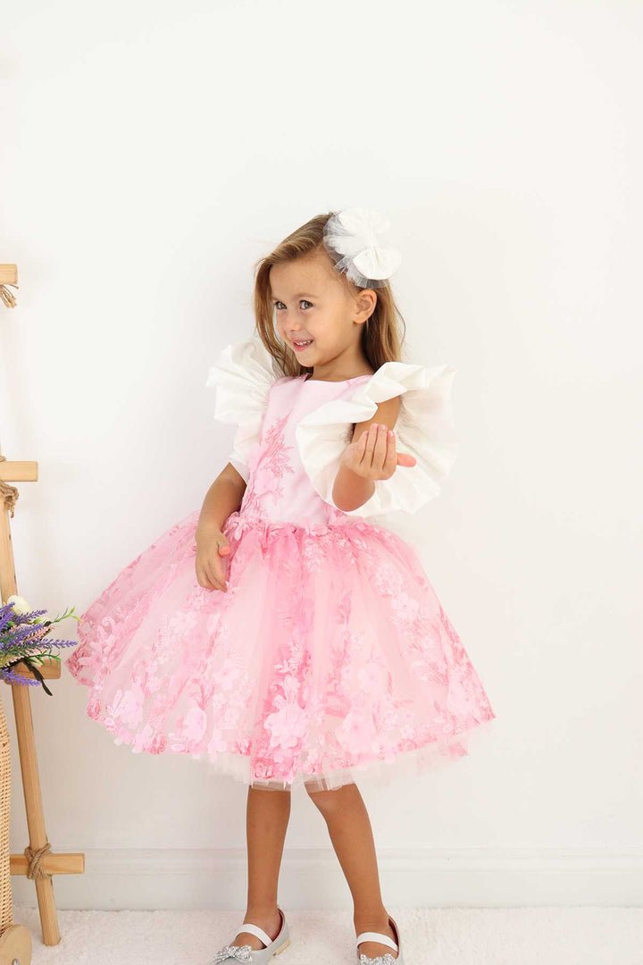 A pink birthday party dress. The dress has 3D floral design, puffy skirt, and balloon arm
