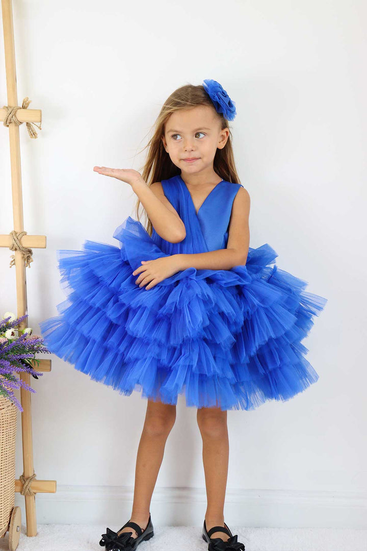 A sax blue sleeveless frozen themed dress that has knee length multi layered puffy skirt and V-neck