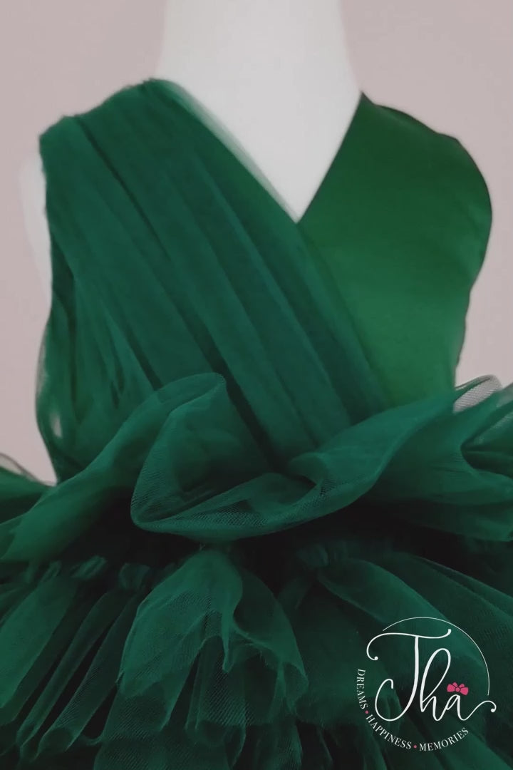 360° view of a green sleeveless tutu dress that has knee length multi layered puffy skirt and V-neck