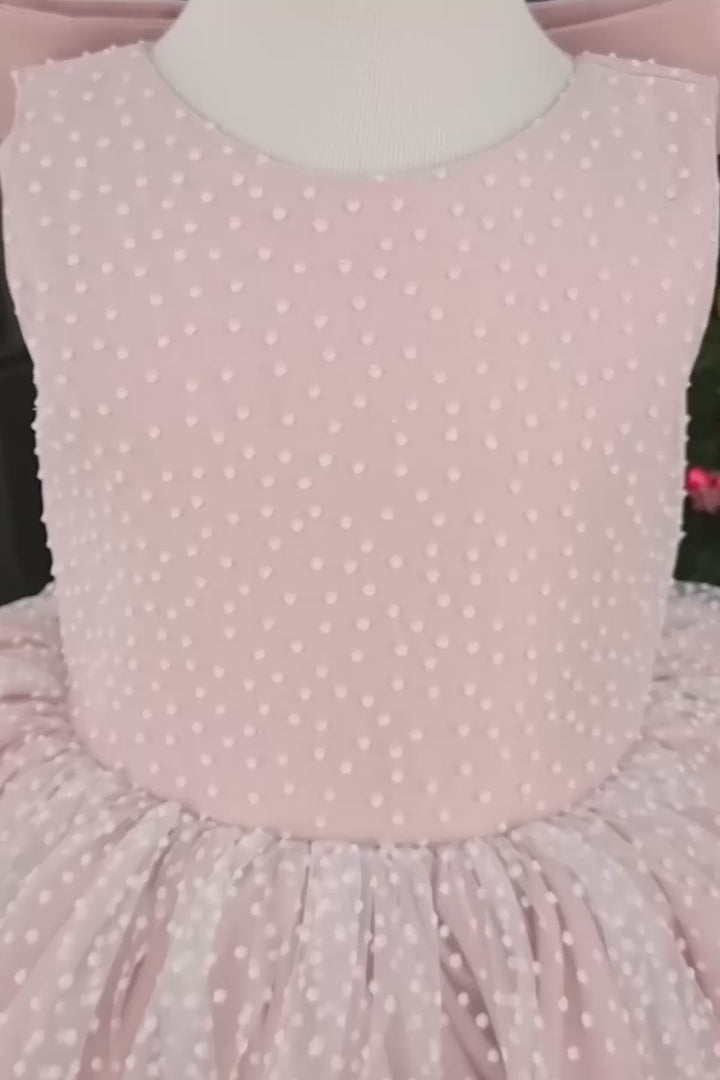 360° view of a pink sleeveless birthday dress that has snow foam, knee length fluffy skirt, bow, and satin top