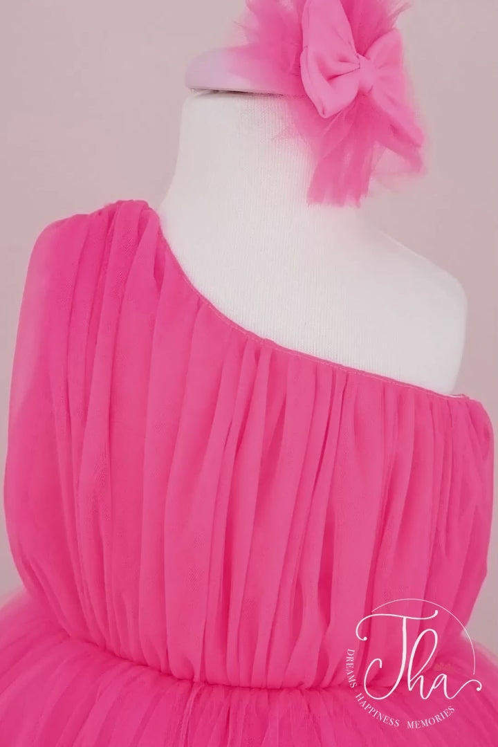 360° view of a pink one shoulder open sleeveless summer fairy dress that has knee length shirred skirt