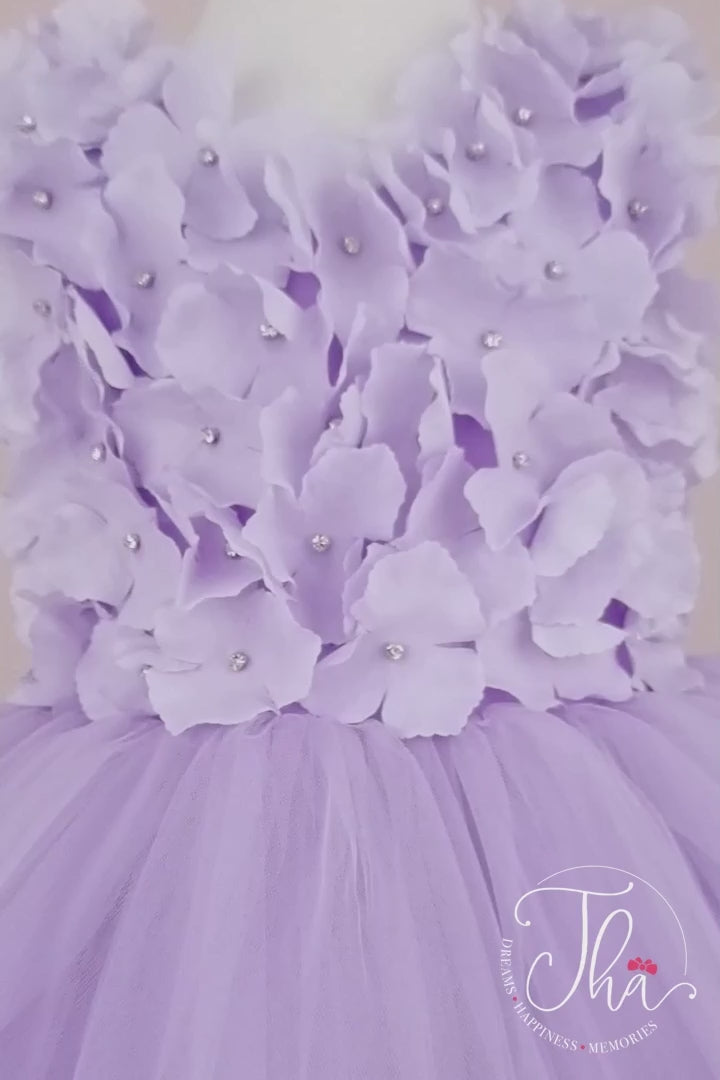 360° view of a lilac first birthday dress which has 3D lilac flowers and attached rhinestones on top and fluffy skirt