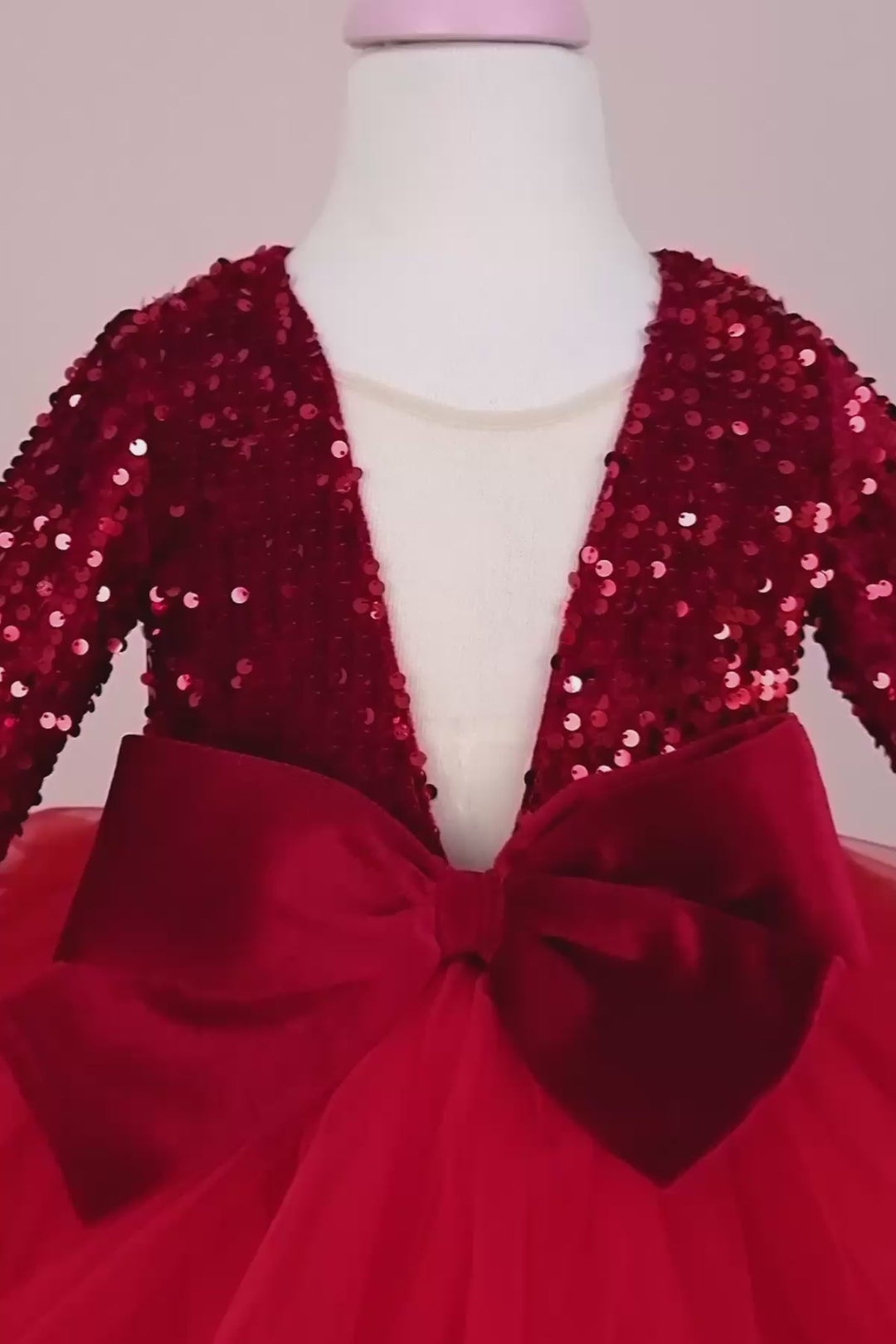 360° view of a red long sleeve fairy dress that has illusion V neck, red velvet belt and bow, fluffy skirt with grainy tulle, and red sequin top