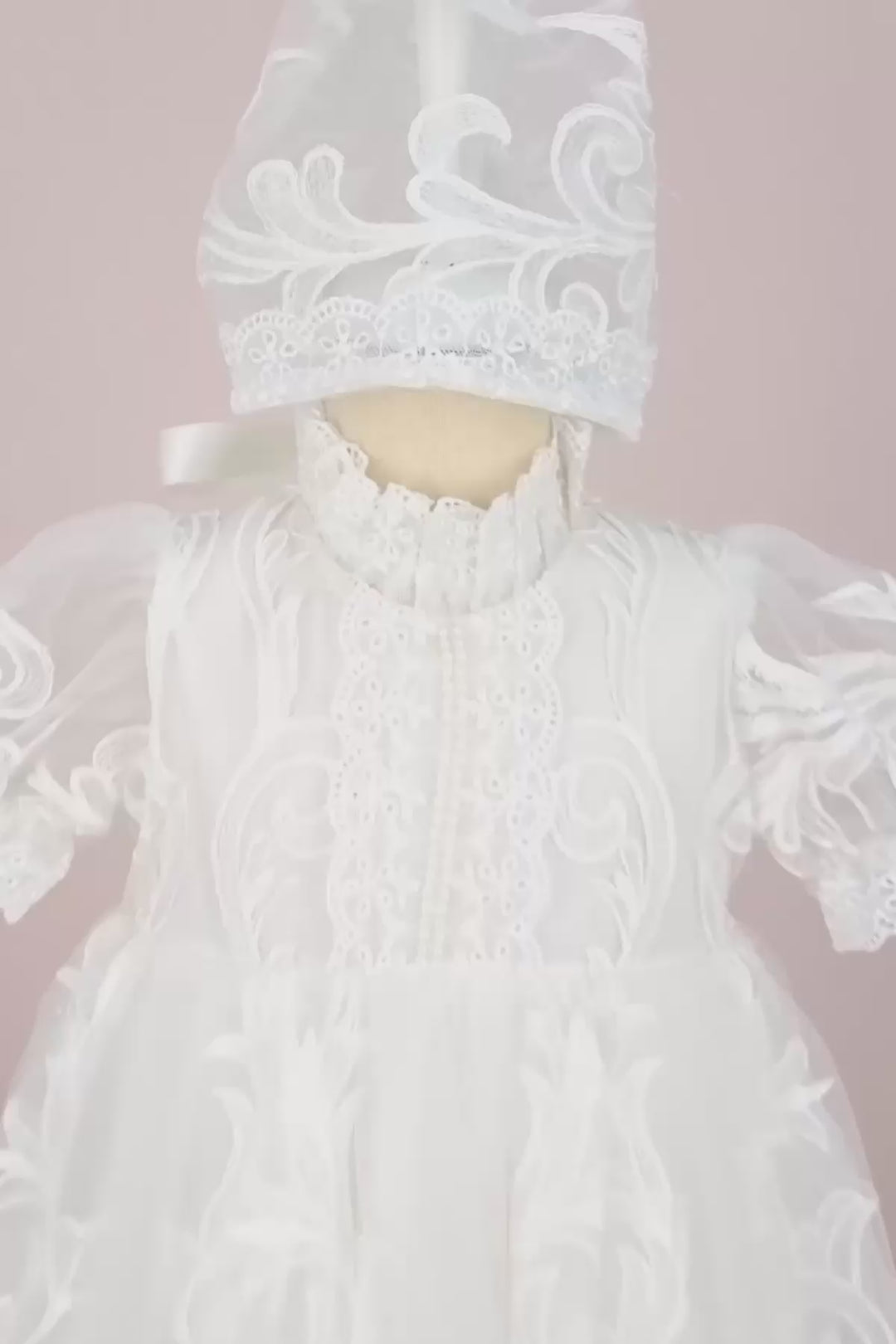 360° view of a white half sleeve baptism dress and baptismal bonnet. The dress is floor length and has French lace
