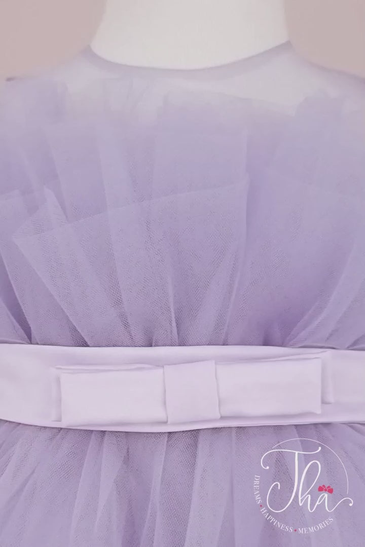 360° view of a light lilac sleeveless tutu princess dress that has knee length fluffy multi layered skirt, belt, and lilac illusion collar.