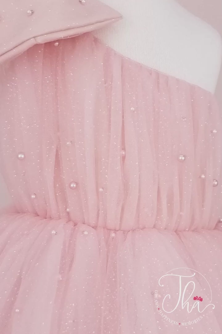 360° view of a gold cotton candy dress that has one shoulder open design, bow, pearls, and fluffy knee length skirt