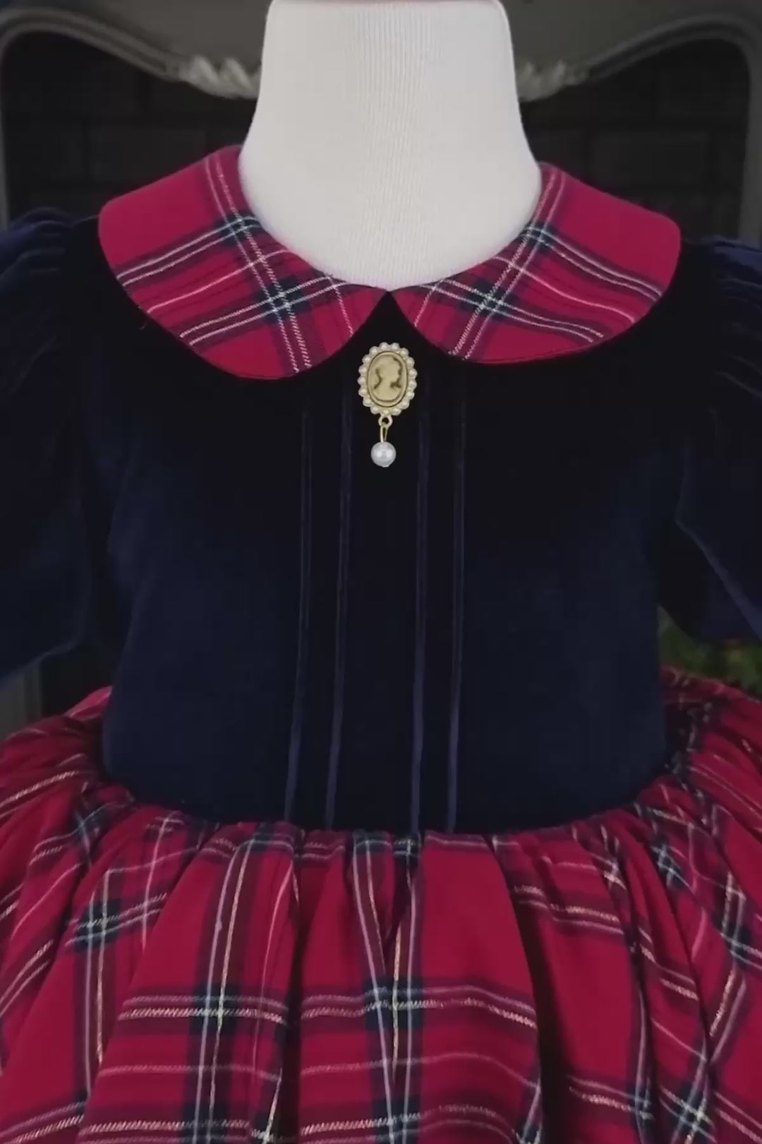 360° view of a navy blue velvet Christmas dress that has plaid skirt, balloon arm, baby collar and brooch.