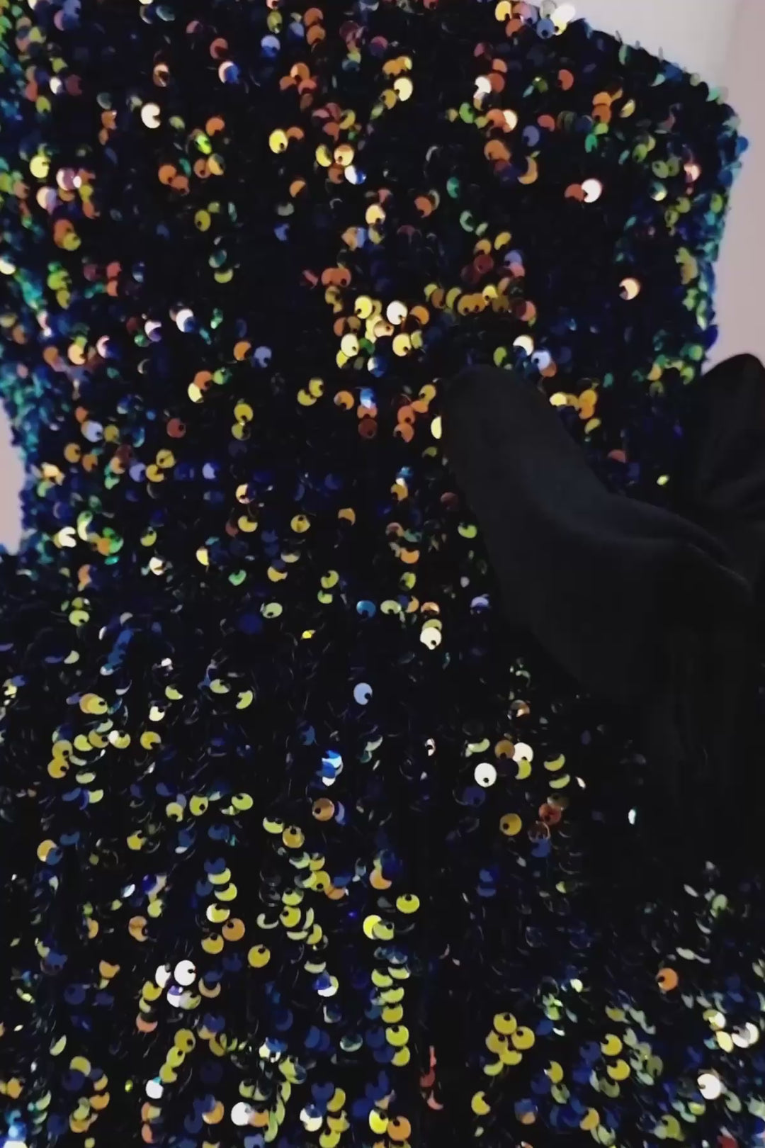 360° view of a black hologram sequin one shoulder open Christmas dress that has velvet ribbon and knee length skirt