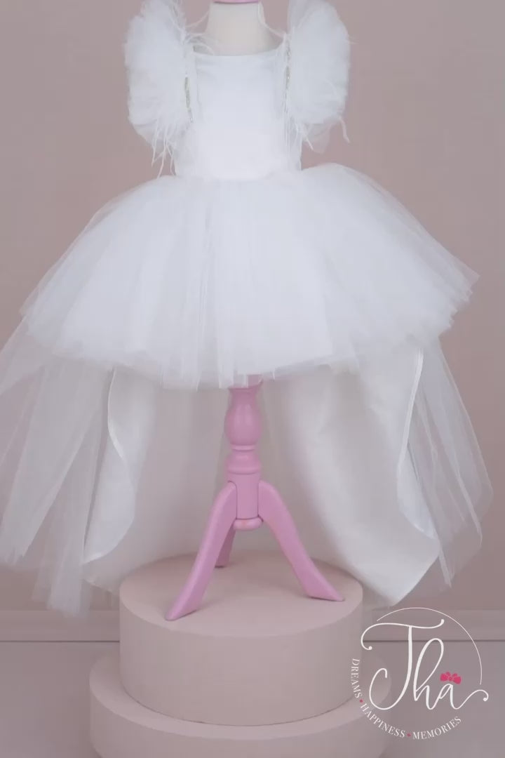 360° view of a white sleeveless bridesmaid dress that has hi-low tulle skirt, V-design, tulle design from sleeves to the back, and feathers
