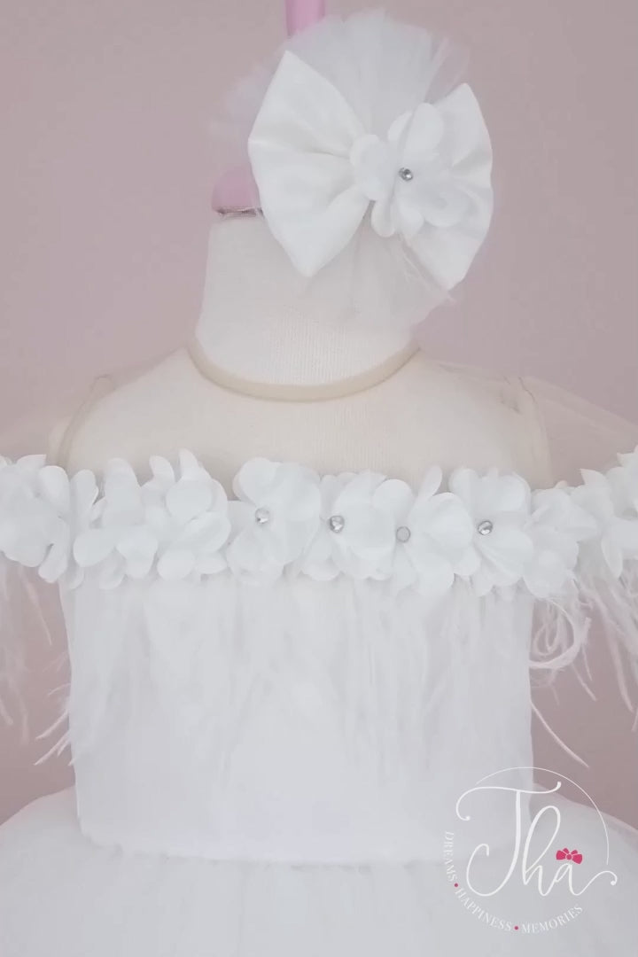 360° view of a white sleeveless bridesmaid dress that has 3D flowers with rhinestones, cap sleeve, feathers, illusion collar, satin top, and knee length skirt