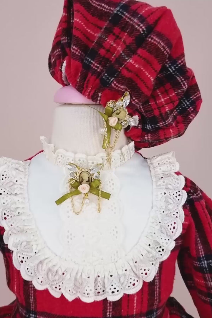 360° view of a red plaid print velvet Christmas dress set that has long sleeves, belt, hat, brooch, and shoes
