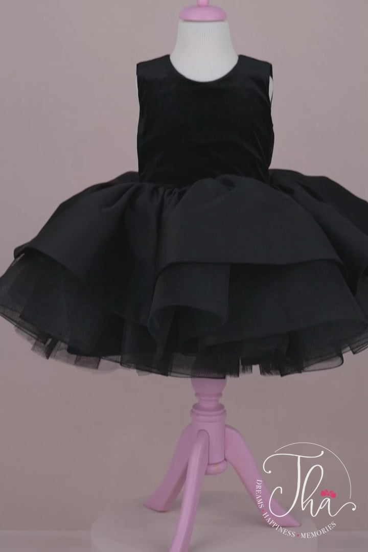 360° view of a black velvet tutu princess. The dress has a knee-length skirt. The skirt is made of layers of black tulle