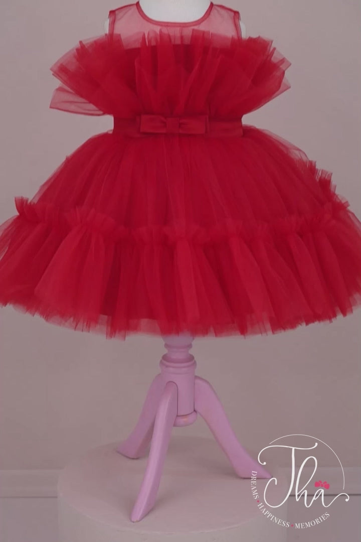 360° view of a red sleeveless Christmas dress that has knee length fluffy multi layered skirt, belt, and red illusion collar