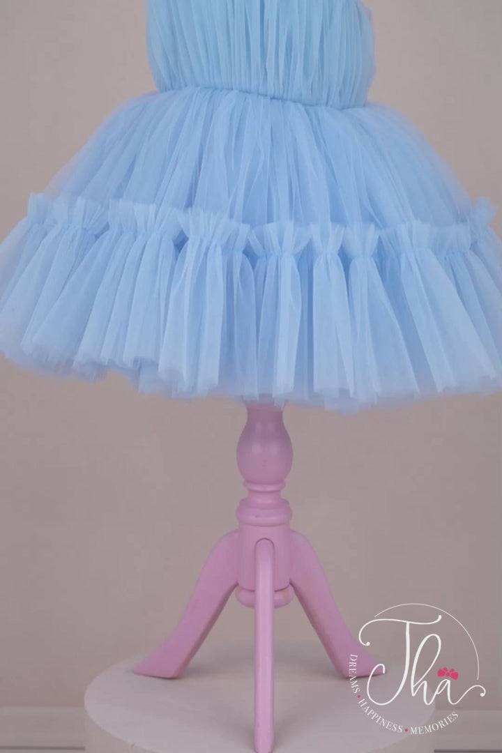 360° view of a baby blue one shoulder open sleeveless Smurf concept dress that has knee length shirred skirt