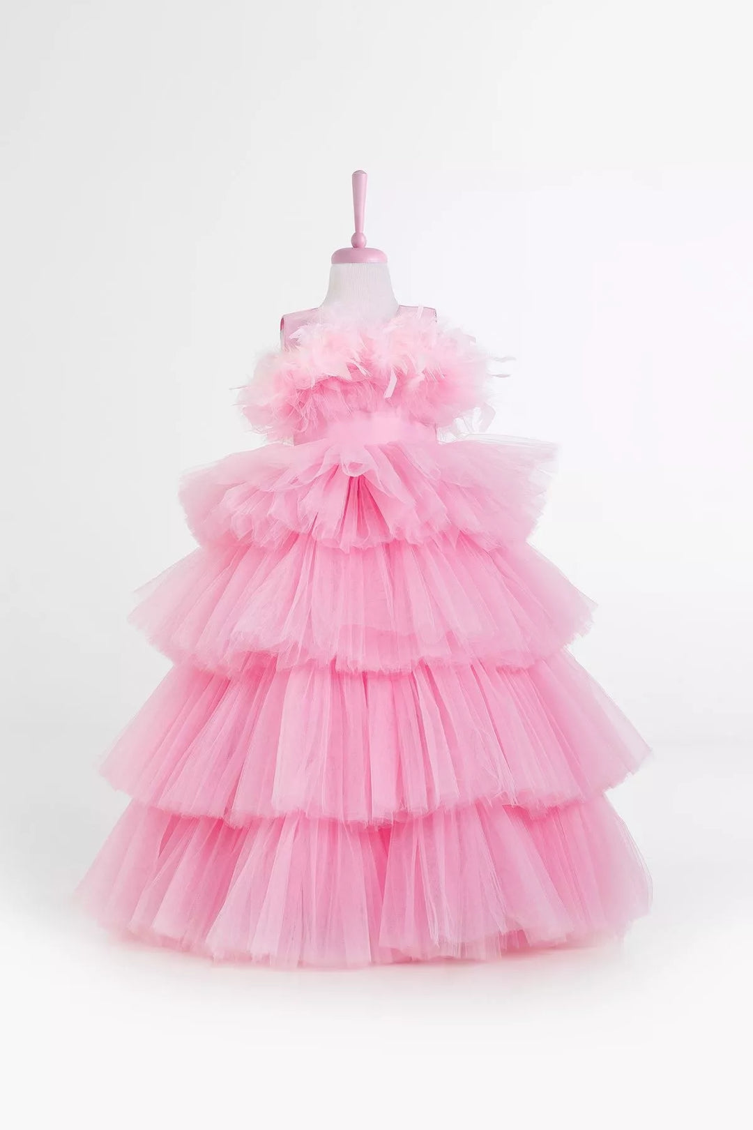 A sleeveless pink princess wedding dress. The dress has floor length skirt, satin top, and feathers on chest