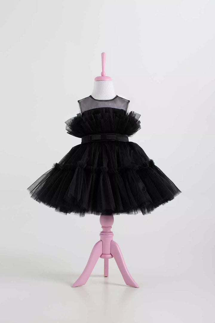 A black sleeveless tutu princess dress that has knee length fluffy multi layered skirt, belt, and black illusion collar