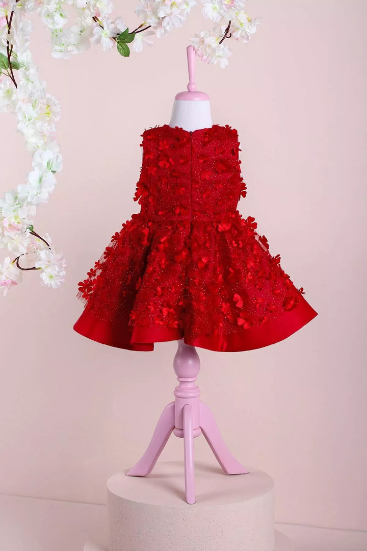 Back view of a red floral sleeveless Little Red Riding Hood dress that has 3D flowers and red puffy skirt