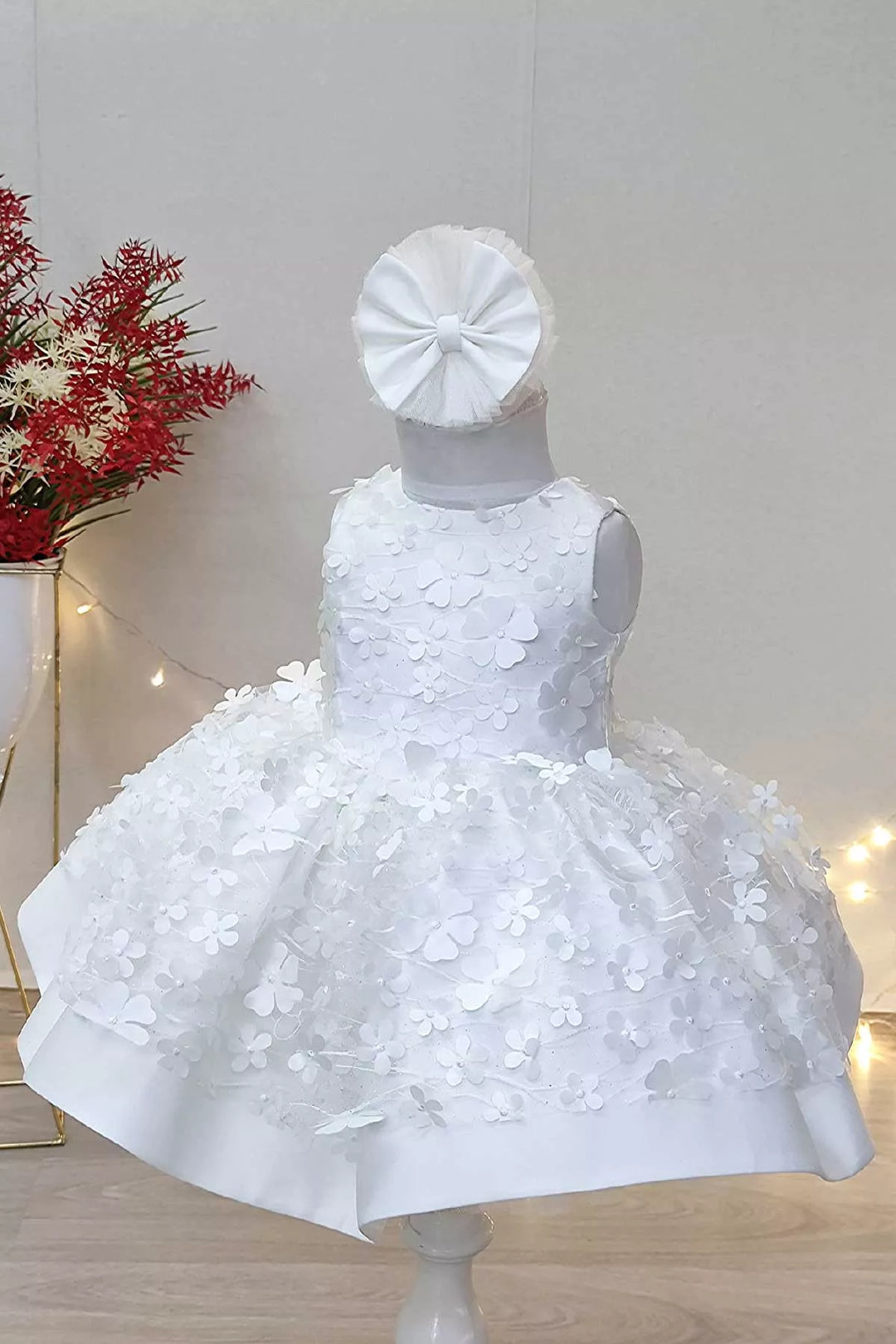 A white snow themed floral sleeveless dress that has 3D flowers and puffy skirt
