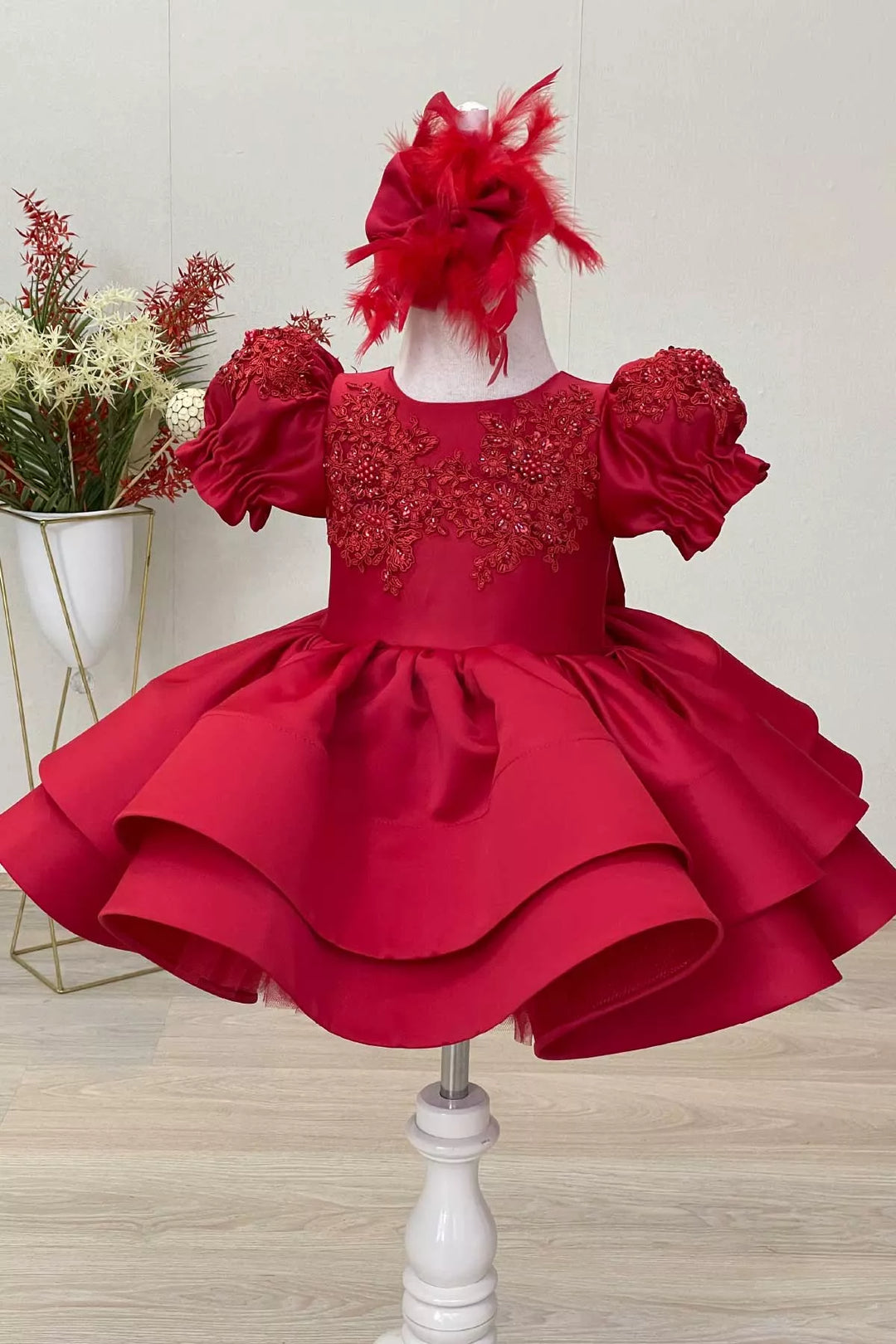 A red special designer ball gown that has French lace, balloon arm, and satin 2 layers knee length skirt