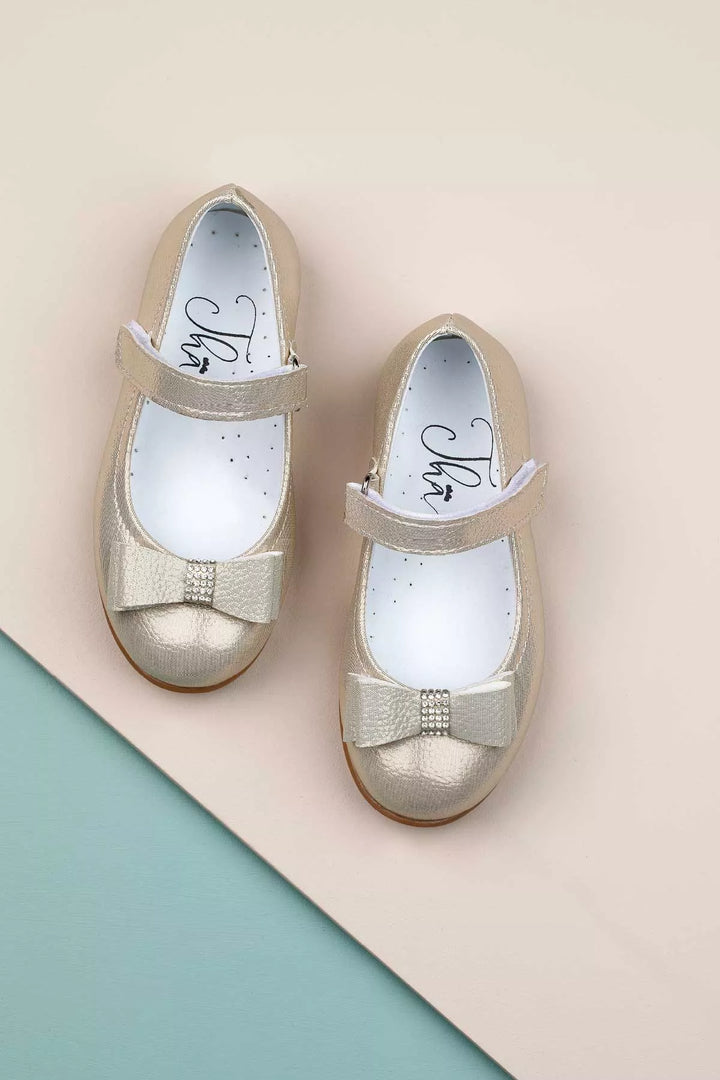 Gold toddler shoes that have crystal stone ornaments and bow tie