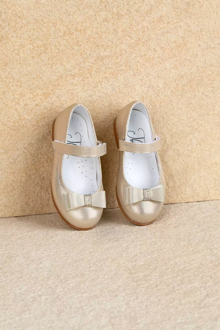 Gold toddler shoes that have crystal stone ornaments and bow tie