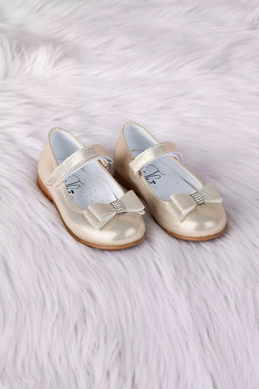 Gold toddler shoes that have crystal stone ornaments and bow tie